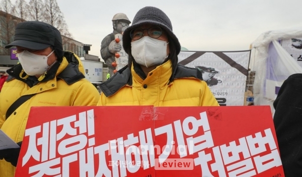 4일 오후 서울 여의도 국회 앞에서 열린 중대재해기업처벌법 제정 촉구 재난참사 피해자 입장발표 기자회견에서 한 참석자가 법안 제정을 촉구하는 손피켓을 들고 있다./사진=연합뉴스