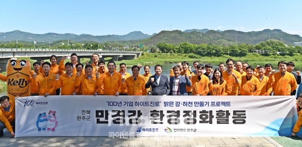 하이트진로가 13일 전북 완주군 만경강에서 하이트진로 김인규 대표(앞줄 왼쪽 네번째), 완주군 유희태 군수(앞줄 왼쪽 다섯 번째) 등 임직원들이 참석한 가운데 만경강 환경정화활동을 진행했다. / 사진=하이트진로